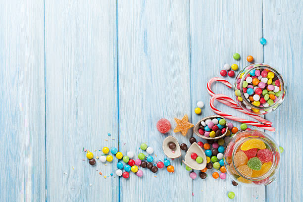 istock Colorful candies on wooden table 521532768