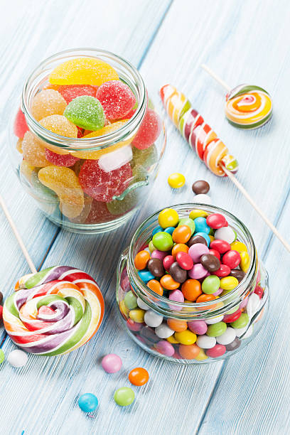 istock Colorful candies on wooden table 521532812