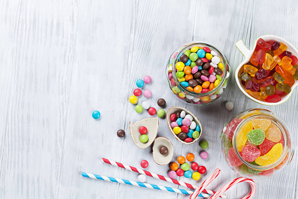 istock Colorful candies on wooden table 521532852