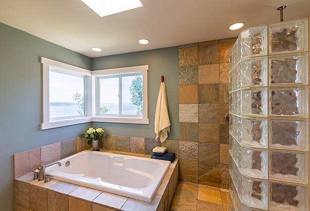 Modern bathroom interior with bathtub, cabinet and shower
