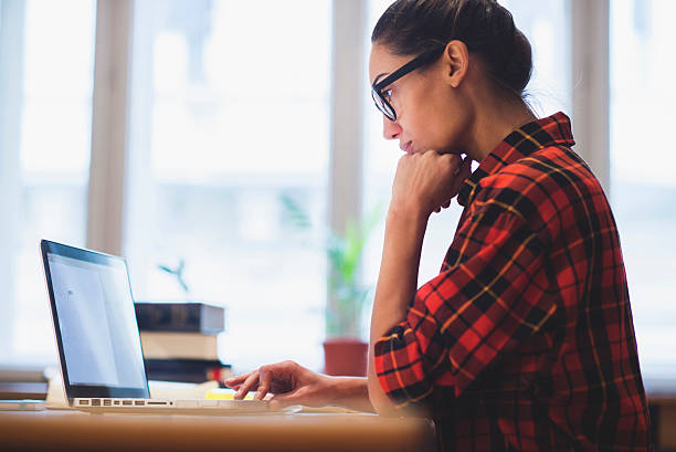 Working Young woman working on laptop e learning stock pictures, royalty-free photos & images