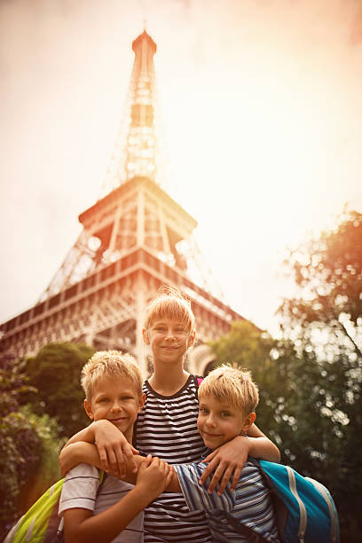 istock Kids tourists smiling at the camera near Eiffel Tower 521538834
