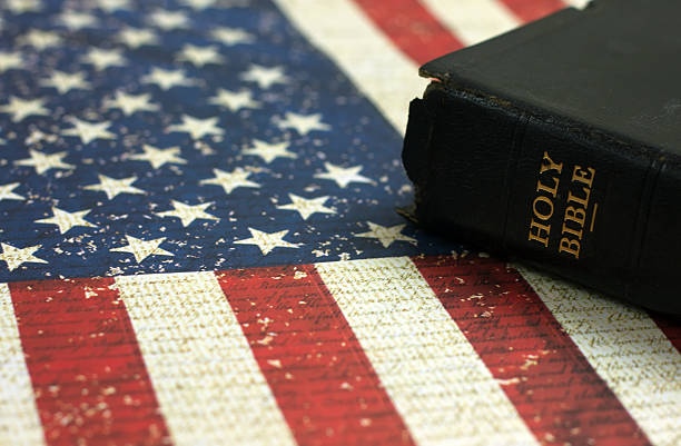 istock Old Holy Bible and the American Flag 521539510