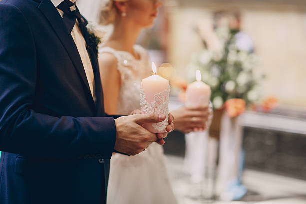 istock hands candle church wedding 521539576