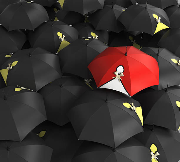 istock Red umbrella stand out from the crowd 521540782