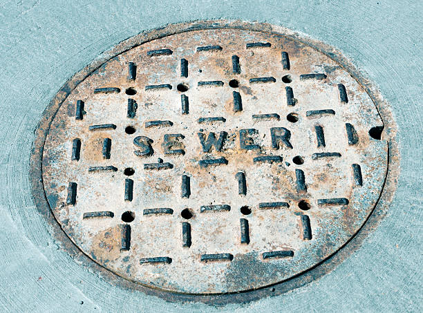 istock Metal sewer cover in fresh concrete 521543814