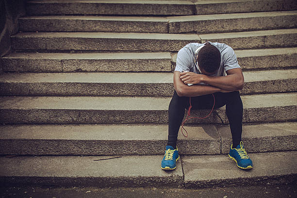 istock Young fit man relaxing on the stairs, after strenuous workout 521544780