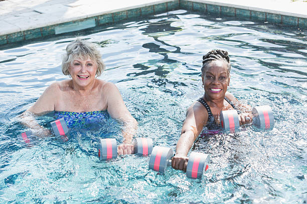 istock Senior women in pool doing water aerobics 521545848