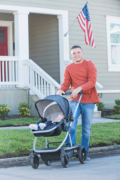 istock Father pushing his baby girl in stroller 521546408