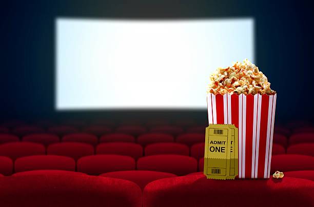 Cinema seat and pop corn facing empty movie screen Cinema seat and pop corn facing empty movie screen box office photos stock pictures, royalty-free photos & images