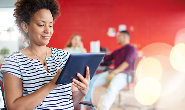 istock Confident female designer working on a digital tablet in red 521548826