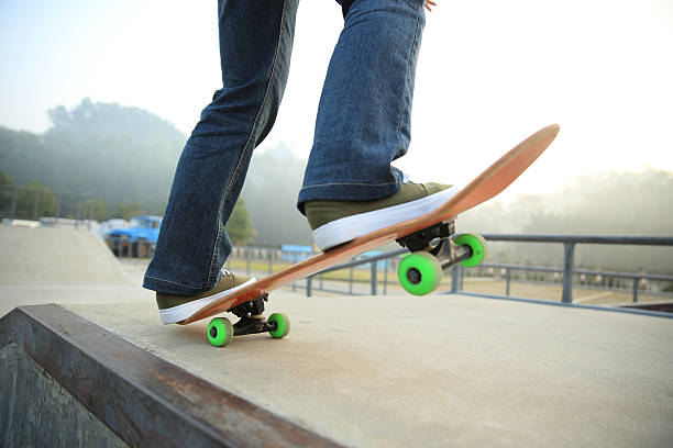 istock skateboarding legs at skatepark 521548860