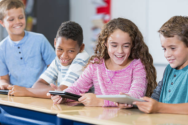 istock Multi-ethnic group of children in class, digital tablets 521549772