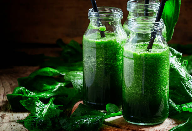 istock Green detox drink, a glass bottle 521550526