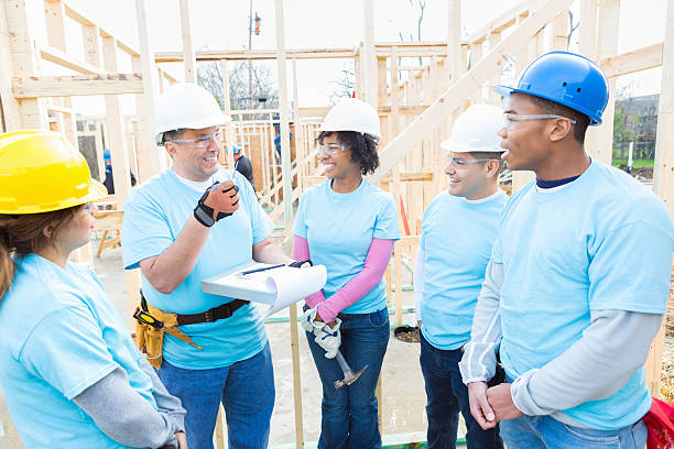 istock Construction manager gives assigment to volunteers 521550730