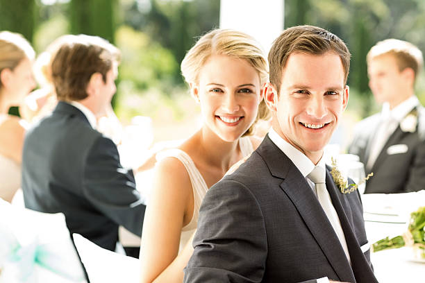 istock Bride And Groom With Wedding Guests In Background 521575225