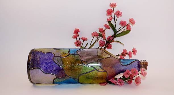 istock Colorful bottle with pink flowers 521577079