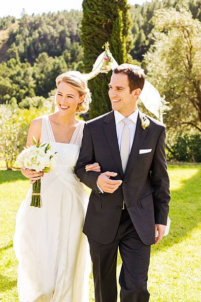 istock Newlywed Bride And Groom Walking In Garden 521577443