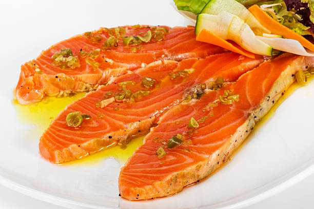 istock Salmon carpaccio with chopped vegetables in a restaurant 521578185