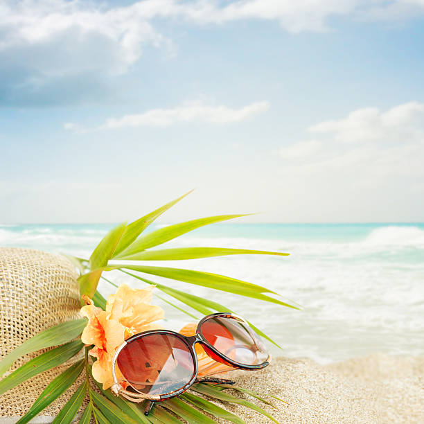 istock Sunglasses on the  sand beach 521578277