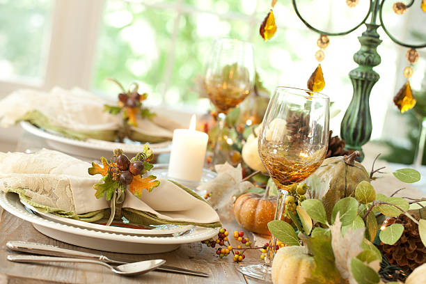 istock Thanksgiving autumn dining table place setting and Christmas tree lights 521578565