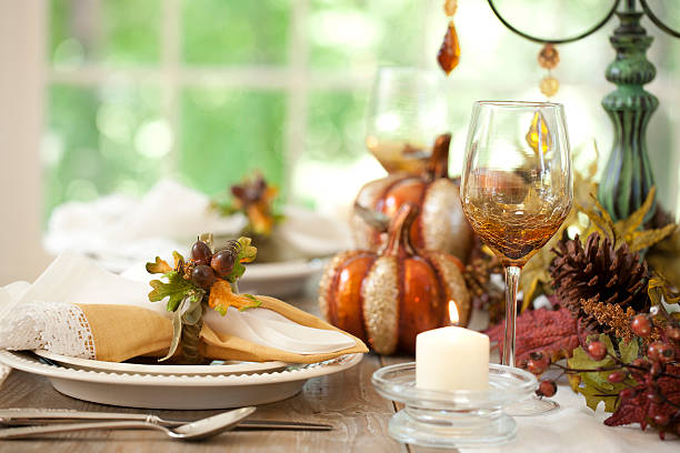 istock Thanksgiving autumn dining table place setting and Christmas tree lights 521578891