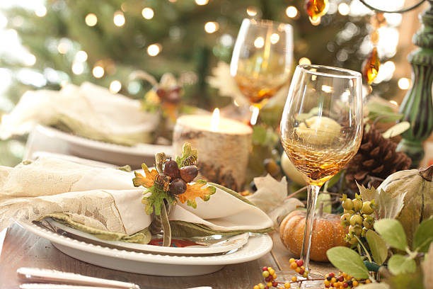 istock Thanksgiving autumn dining table place setting and Christmas tree lights 521578893