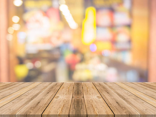 istock Wooden board empty table blur in coffee shop. 521600778