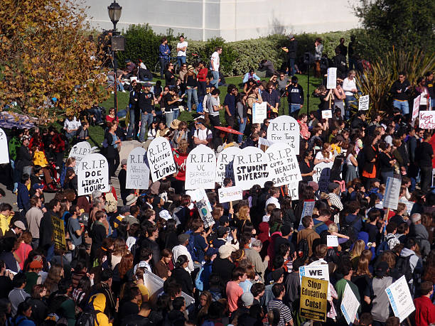 Berkeley, USA - November 18, 2009: crowd of protesters hold signs and rally tuition increases in front of Sproul Hall on UC Berkeley November 18 2009 at Berkeley, California.