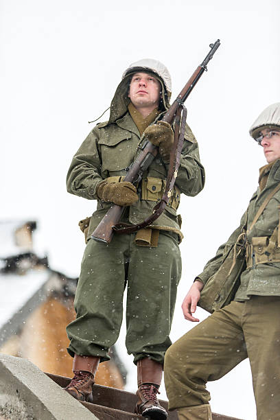 World War II: Victory Cheer After Storming Bunker Stock photograph of WWII platoon with rifles raised after taking a bunker during a fierce battle in a blizzard. storming stock pictures, royalty-free photos & images