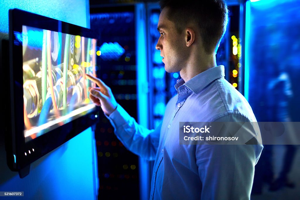 Interactivity Man using touchscreen in university or museum Touch Screen Stock Photo