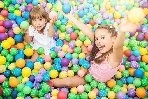 Happy child playing in colored balls