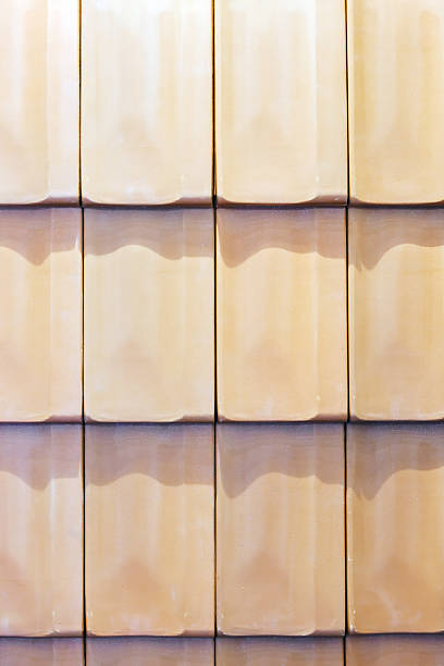 Full frame of orange colored tiles a bit weathered on roof top