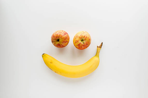 istock Apples and banana shaped into a smiling face 521612324
