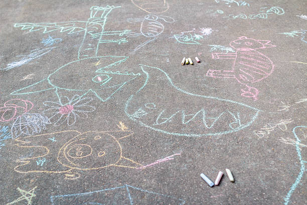 Tarmac covering with sidewalk chalking drawings Tarmac is covering with sidewalk chalking drawings pastel crayon photos stock pictures, royalty-free photos & images