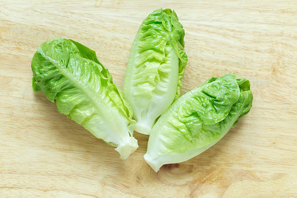 istock Cos Lettuce on wood background 521614724