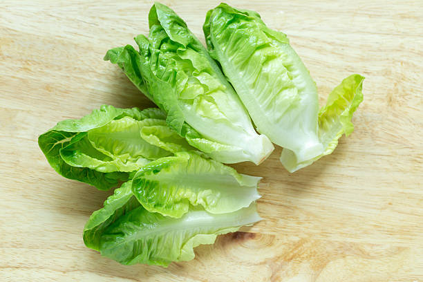 istock Cos Lettuce on wood background 521615316