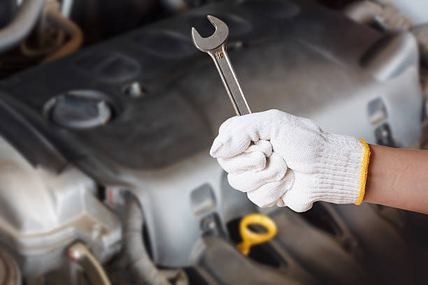 istock Hand of auto mechanic with wrench 521615638