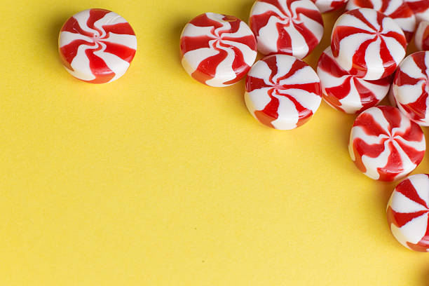istock Candies colorful mix on yellow bright background with copy space 521616010