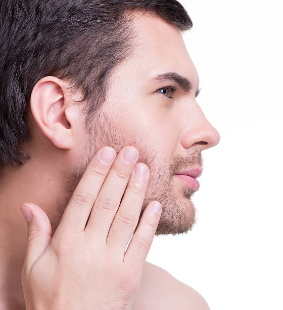 istock Handsome man with hand near the face 521617016