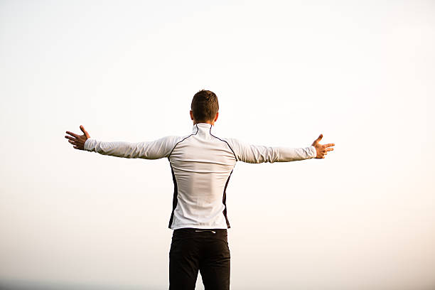 istock Man with outstretched arms against sky 521617854
