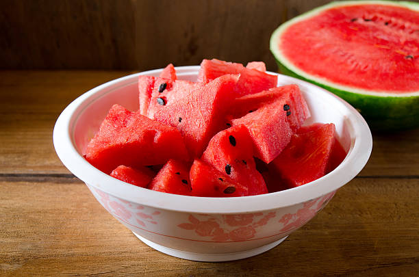 istock Fresh sliced watermelon wooden background 521617940