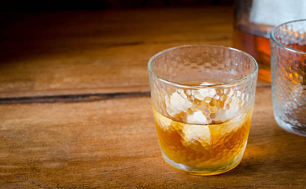istock Bottle and glass of whiskey with ice 521618004