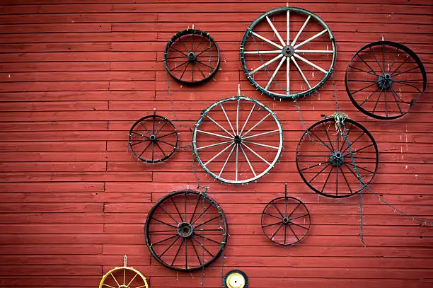 Photo of Antique wagon wheels on an old barn