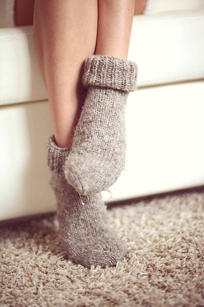 istock female legs in woolen socks close up 521618509
