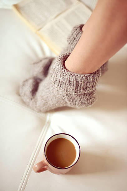 istock female legs in woolen socks close up 521618511
