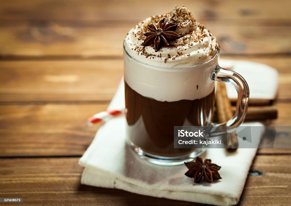 Hot Chocolate Hot Chocolate with whipped cream,cinnamon and star anise served on a wooden table Hot Chocolate Stock Photo