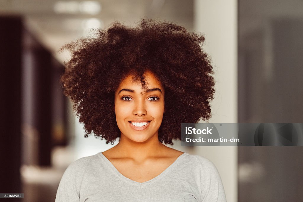 Smiling afro-american woman looking at camera Portrait of beautiful mixed-race woman looking at camera One Woman Only Stock Photo