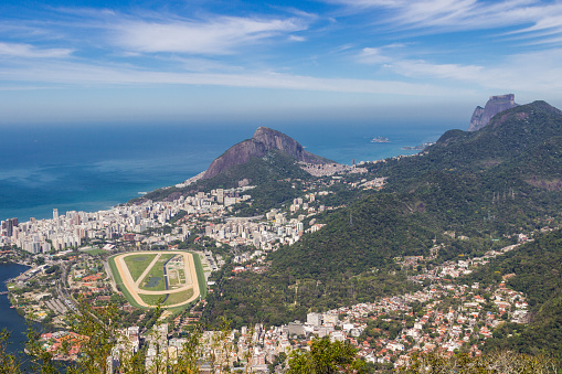 Image of Rio de Janeiro with it's contradictions in landscape and living conditions on the border between the vast Atlantic Ocean and the South American continent rising out of it.