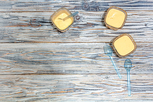 istock Three jars of yogurt stands on the aged boards 521619646